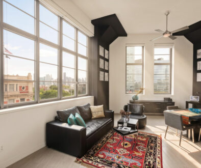 loft living room with extra high windows, view of Manhattan